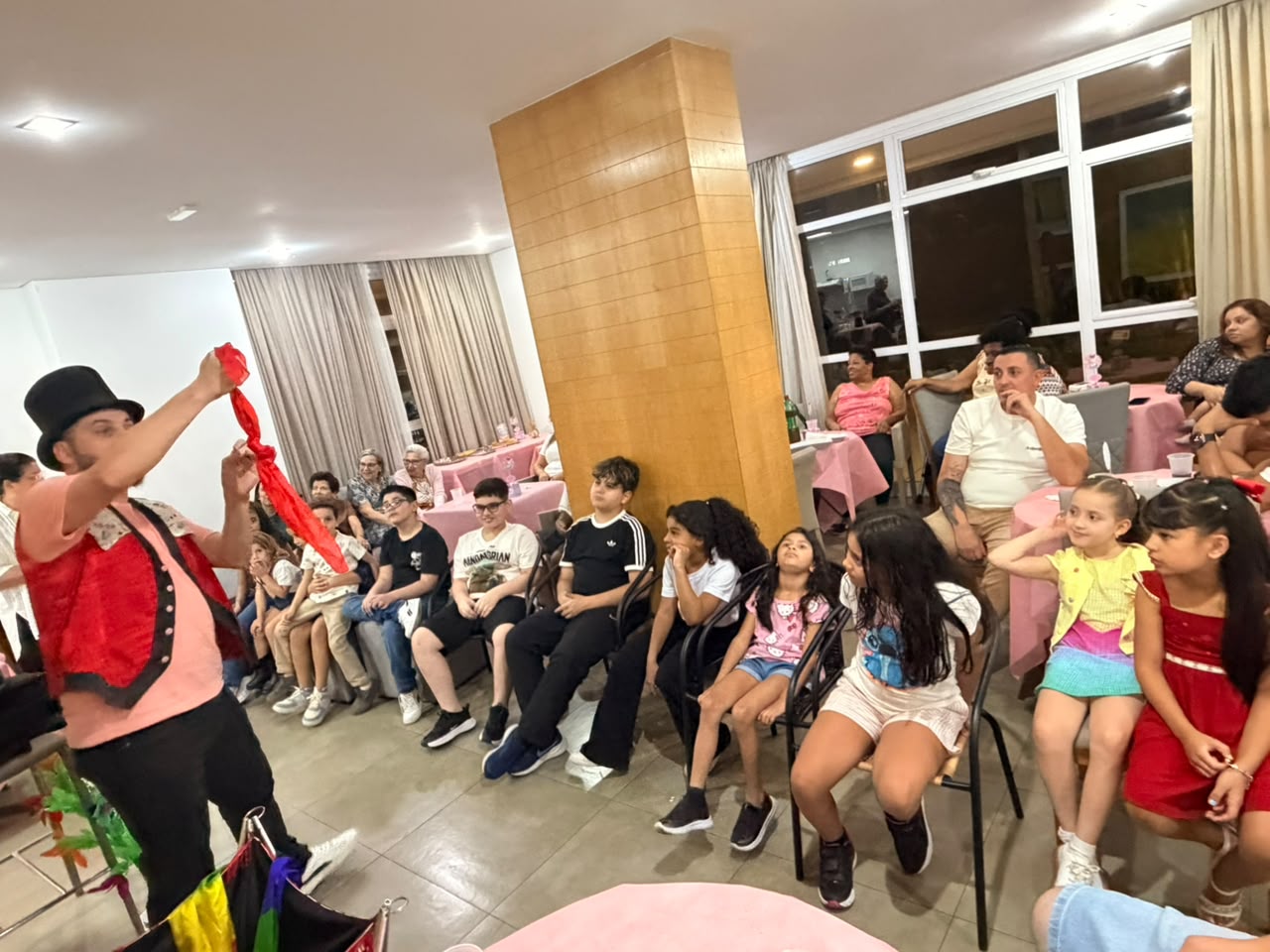 Crianças encantadas assistindo ao show de mágica